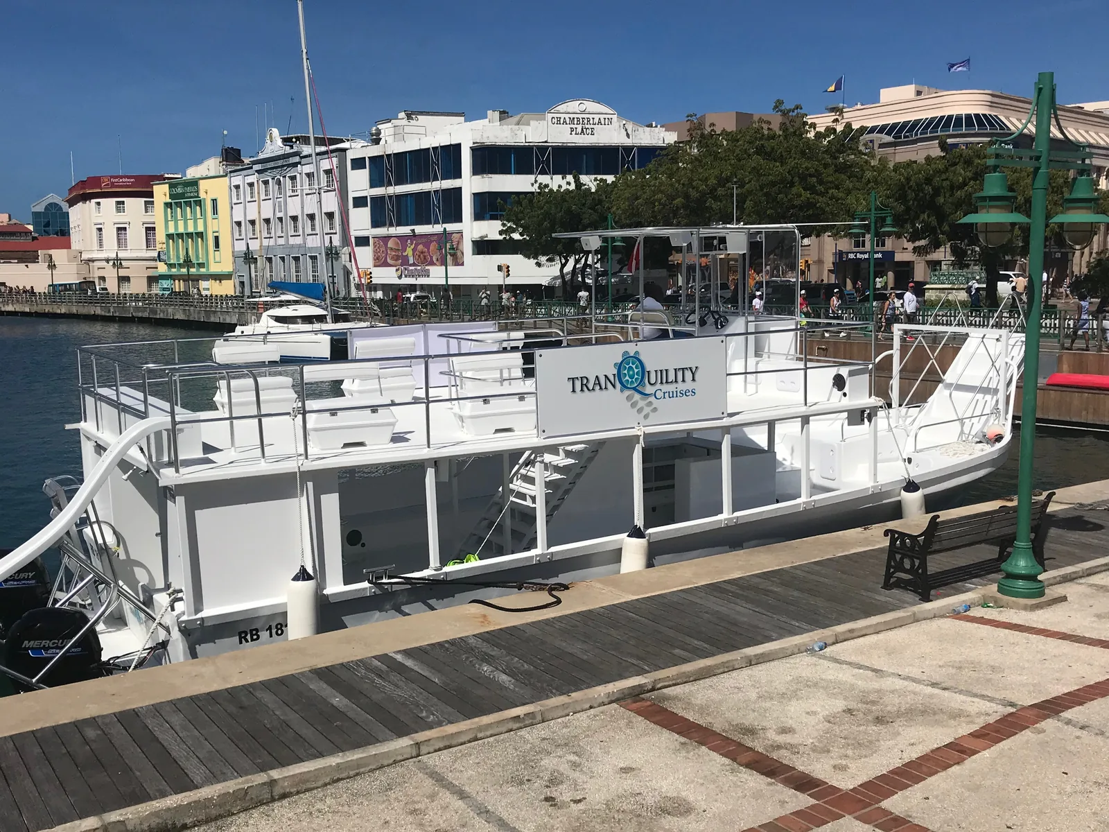 The Tranquility Cruises boat tied up at the Careenage in Bridgetown, slide rigged off the stern