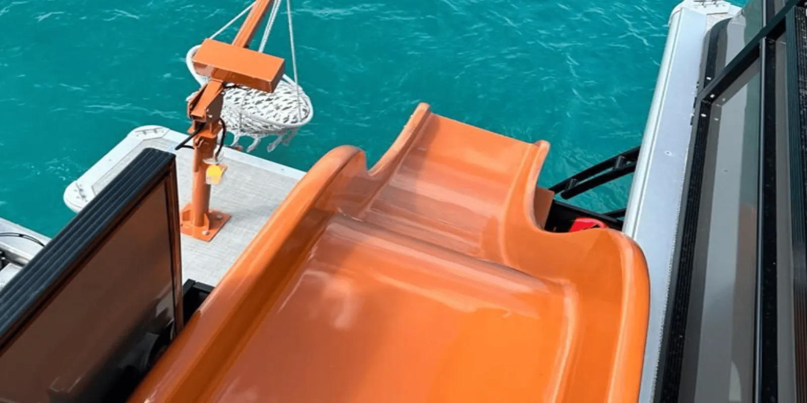 The orange slide running off the upper deck into the water
