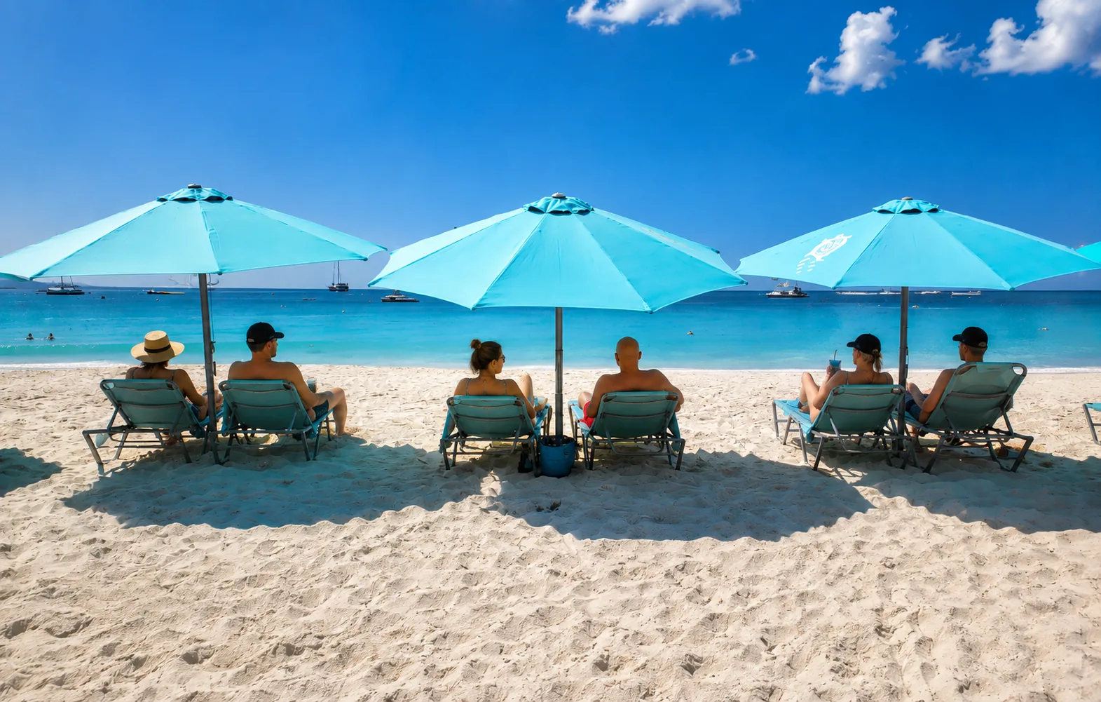 Rows of turquoise beach umbrellas and loungers on the white sand at Carlisle Bay